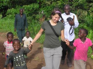 Student in Tanzania with children.