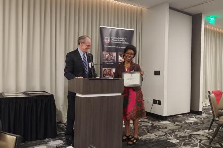 Dean Dorsey presents award to Dr. Maganda.